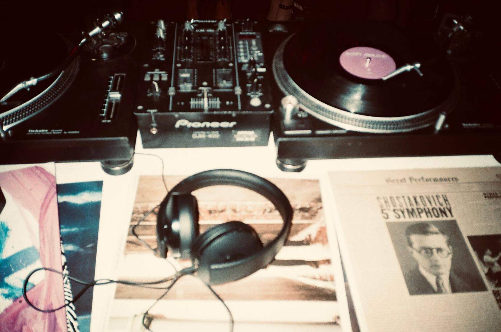 DJ's turntables, headphones, and vinyl crate up close