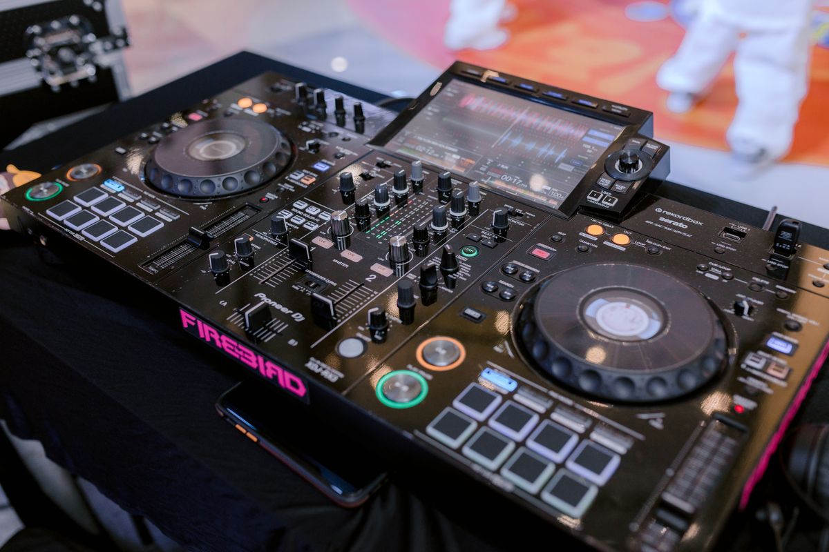 DJ booth setup with mixer and laptop at a wedding reception