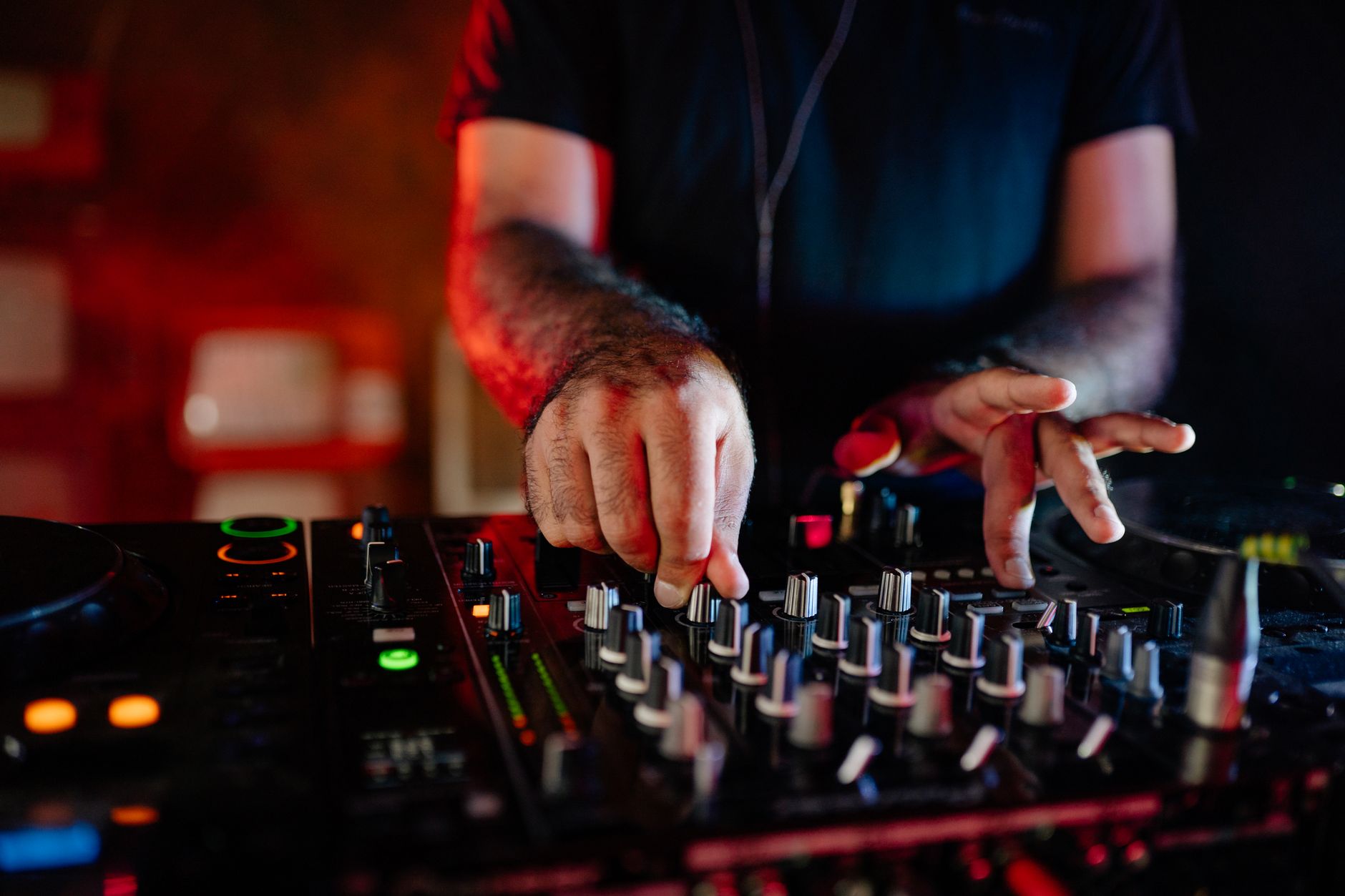 Close-up of a DJ cueing a track on a controller during a wedding set