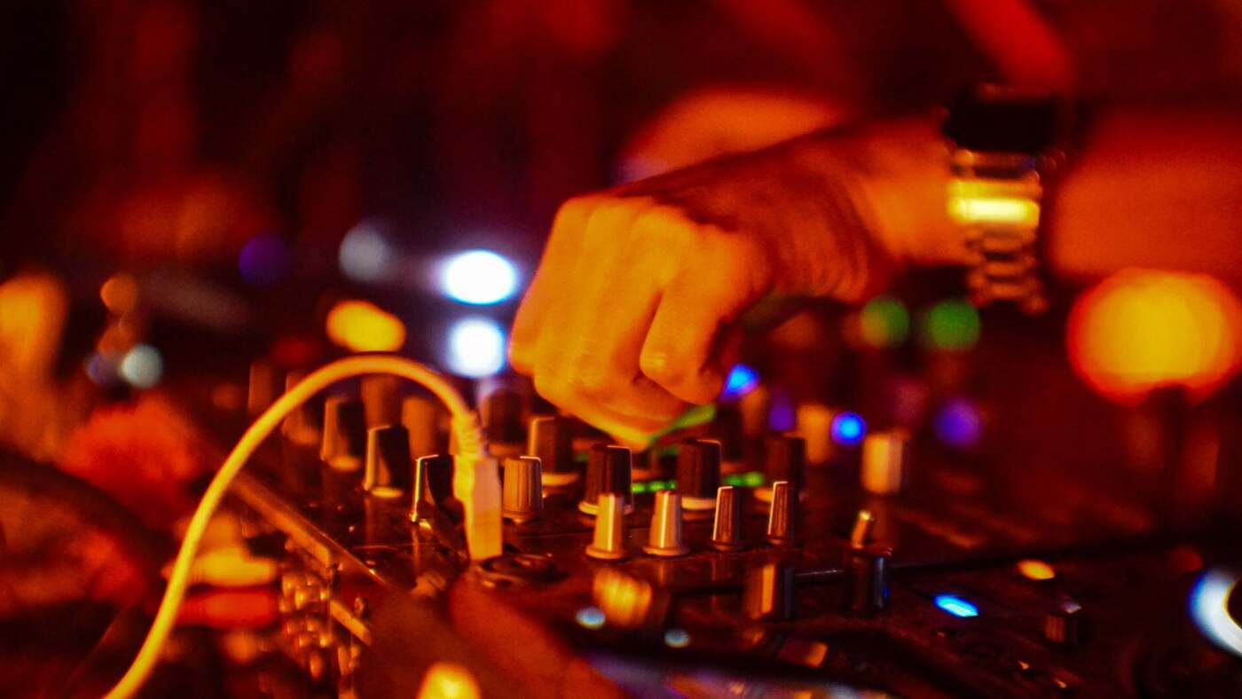DJ mixing at a club night, building energy through a set