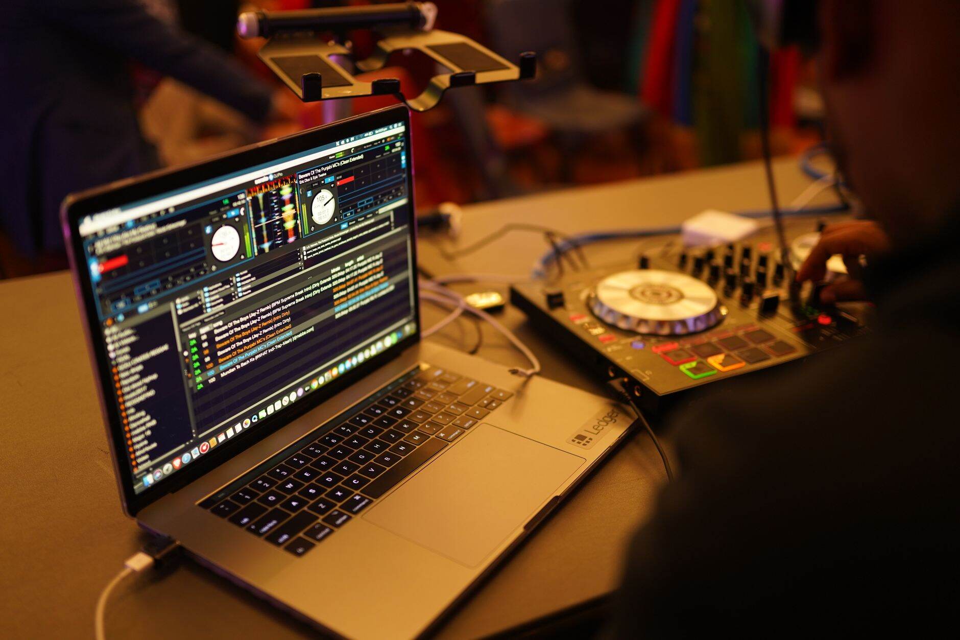 DJ laptop screen showing organized Serato crate folders before a gig