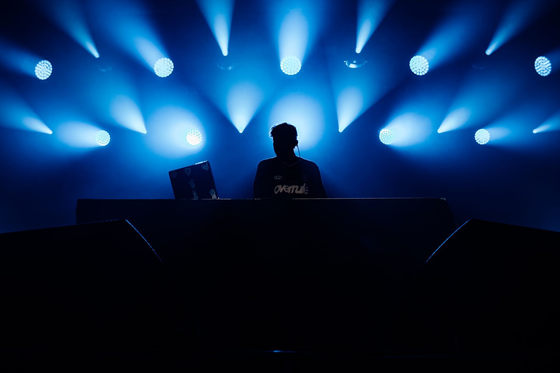 DJ set up with laptop and controller ready to perform, crate system prepped
