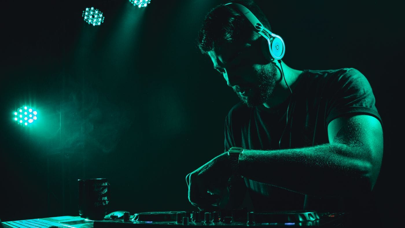 DJ mixing tracks in a club while rebuilding the dance floor's energy