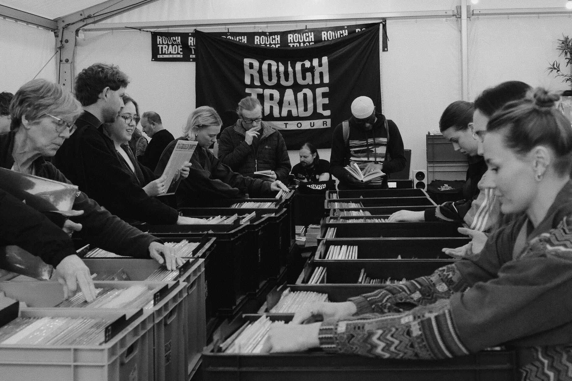 DJs and collectors digging through crates at a record store event, one of the lanes where djs get their music